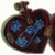 A wind up heart toy showing the heart open in two halves with the inner working & cogs on display...