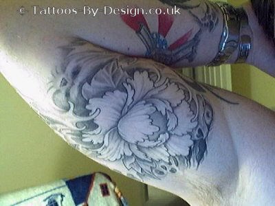 Flower Tattoo   on Asian Flower With Partial Skull Faces Peaking Out