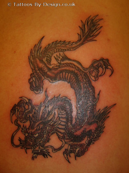black and grey shadded dragon Tattoo