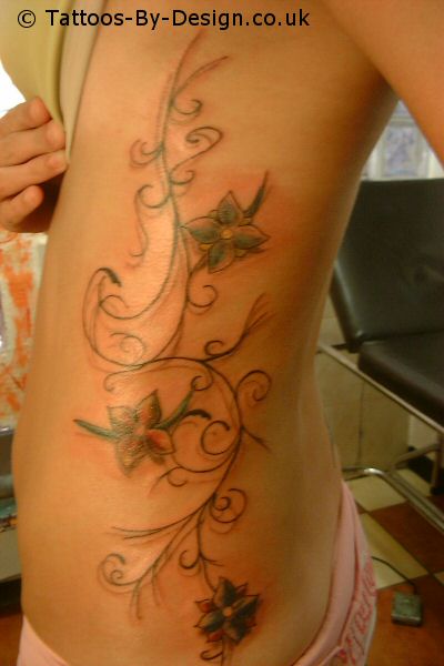 rib cage tattoo. Nice Flower Lower Back Tattoo